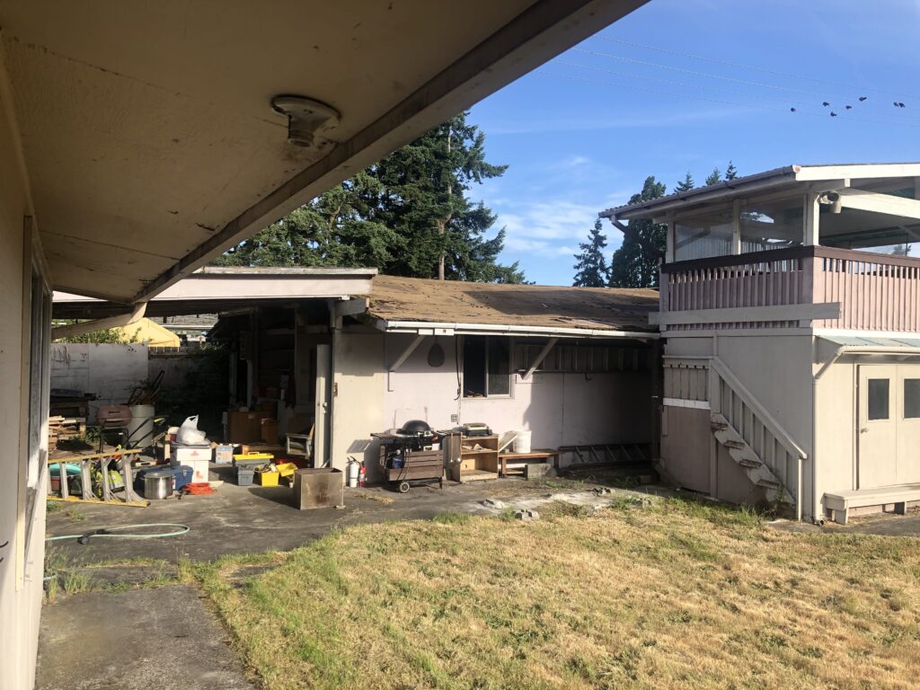 Exterior of a damaged inherited house in need of repairs before selling inherited property.